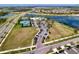 An aerial view of the community pool, tennis courts, park, and lake, set amongst lush landscaping at 6136 Voyagers Pl, Apollo Beach, FL 33572