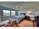 Well-lit bedroom with a comfortable bed, large windows, and a dresser at 6136 Voyagers Pl, Apollo Beach, FL 33572