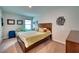 Cozy bedroom with neutral walls, a queen bed, and matching furnishings at 6136 Voyagers Pl, Apollo Beach, FL 33572