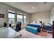Well-lit bedroom with a bed, desk, and large windows at 6136 Voyagers Pl, Apollo Beach, FL 33572
