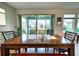 Formal dining room with hardwood floors, large glass windows, and a backyard view at 6136 Voyagers Pl, Apollo Beach, FL 33572