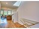 Inviting entryway with hardwood floors, staircase, and living room featuring abundant natural light at 6136 Voyagers Pl, Apollo Beach, FL 33572