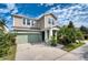 Charming two-story home with well-manicured lawn, featuring an attached garage and covered front porch at 6136 Voyagers Pl, Apollo Beach, FL 33572