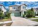 Charming two-story home with a well-manicured lawn and attached two-car garage at 6136 Voyagers Pl, Apollo Beach, FL 33572