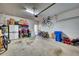 Organized garage with storage solutions, including shelving and cabinets, accommodating bikes and lawn equipment for versatile use at 6136 Voyagers Pl, Apollo Beach, FL 33572