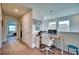 Bright home office space with desk, chair, and natural light from multiple windows at 6136 Voyagers Pl, Apollo Beach, FL 33572