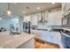 Modern kitchen with stainless appliances, white cabinets, tile backsplash, and hardwood flooring at 6136 Voyagers Pl, Apollo Beach, FL 33572