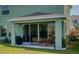 Covered lanai with outdoor seating, ideal for entertaining and enjoying the backyard at 6136 Voyagers Pl, Apollo Beach, FL 33572