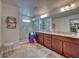 Luxurious main bathroom with a double sink vanity, granite countertop, and glass shower at 6136 Voyagers Pl, Apollo Beach, FL 33572