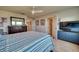 Cozy main bedroom featuring a comfortable bed, dresser, and a television at 6136 Voyagers Pl, Apollo Beach, FL 33572