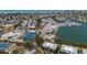 Aerial view of waterfront homes and a tennis court. Features waterfront living, and recreational activities at 6200 Flotilla Dr # 245, Holmes Beach, FL 34217