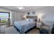 Serene bedroom with beach themed decor, desk and waterfront view at 6200 Flotilla Dr # 245, Holmes Beach, FL 34217