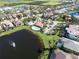 Beautiful aerial view showcasing a community with single-Gathering homes, a pool and a scenic lake with a fountain at 6208 Signature Pointe Ln, Bradenton, FL 34210