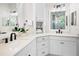 Bathroom features white cabinetry, double sinks, modern fixtures and a flower at 6208 Signature Pointe Ln, Bradenton, FL 34210