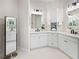 Elegant bathroom featuring dual sinks, custom cabinetry, and a modern vanity mirror at 6208 Signature Pointe Ln, Bradenton, FL 34210