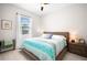 This bedroom offers a bed with decorative pillows, a window, and light walls and flooring at 6208 Signature Pointe Ln, Bradenton, FL 34210