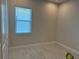 Simple bedroom featuring tile flooring and natural light coming through the window at 6208 Signature Pointe Ln, Bradenton, FL 34210