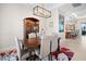 Charming dining area with an elegant dark wood table and view into the kitchen at 6208 Signature Pointe Ln, Bradenton, FL 34210