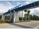 Blue IMG Academy entrance with visible signage and palm trees, offering a welcoming view at 6208 Signature Pointe Ln, Bradenton, FL 34210