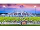 A vibrant football field at sunset filled with fans and players, creating a lively and exciting atmosphere at 6208 Signature Pointe Ln, Bradenton, FL 34210