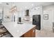 Gourmet kitchen with a large island, modern appliances, and stylish lighting at 6208 Signature Pointe Ln, Bradenton, FL 34210
