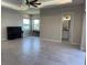 Spacious living room boasts neutral paint, tile flooring, and views of outside from several windows at 6208 Signature Pointe Ln, Bradenton, FL 34210