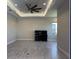 Bright living room with tray ceiling, recessed lighting, and neutral walls has tile flooring at 6208 Signature Pointe Ln, Bradenton, FL 34210