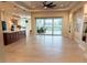 Bright living room featuring tile floors, tray ceiling and large sliding doors to the pool area at 6208 Signature Pointe Ln, Bradenton, FL 34210