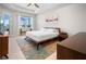 Stylish main bedroom with a tray ceiling, modern artwork, and access to screened lanai at 6208 Signature Pointe Ln, Bradenton, FL 34210