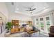 Bright home office featuring tray ceilings, hardwood floors, and multiple work spaces at 6208 Signature Pointe Ln, Bradenton, FL 34210