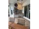 Covered outdoor kitchen with stainless steel grill, granite countertops, and adjacent backyard pool at 6208 Signature Pointe Ln, Bradenton, FL 34210