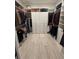 Spacious walk-in closet with ample storage, custom shelving, and hanging rods for organization at 6208 Signature Pointe Ln, Bradenton, FL 34210