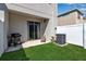 Cozy backyard with lush green grass, grill, patio, and white fence providing a private outdoor space at 6265 Fairmont Ln, Palmetto, FL 34221