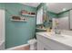 Bathroom featuring green walls, white vanity, and a shower-tub combo at 6265 Fairmont Ln, Palmetto, FL 34221