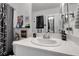 Bright bathroom with white countertops and black accents, featuring decorative wall art and modern fixtures at 6265 Fairmont Ln, Palmetto, FL 34221