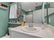Bathroom featuring green walls, white vanity, and a shower-tub combo at 6265 Fairmont Ln, Palmetto, FL 34221