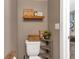 Small bathroom showing toilet with decor on shelf and wall decor with rustic theme at 6265 Fairmont Ln, Palmetto, FL 34221