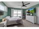 Bedroom featuring green walls, white trim and carpet, along with a ceiling fan at 6265 Fairmont Ln, Palmetto, FL 34221
