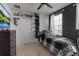 A cozy bedroom with a black accent wall, a ceiling fan, and space saving shelves at 6265 Fairmont Ln, Palmetto, FL 34221