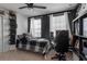 A well-lit bedroom with a dark accent wall, desk and a ceiling fan above the bed at 6265 Fairmont Ln, Palmetto, FL 34221