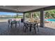 Outdoor area with tables and chairs, pool, and lake views, perfect for relaxing and entertaining at 6265 Fairmont Ln, Palmetto, FL 34221