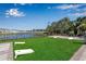Outdoor area with a view of the lake, with green grass and cornhole game setup at 6265 Fairmont Ln, Palmetto, FL 34221
