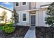 Inviting front entrance with a gray door and decorative landscaping details at 6265 Fairmont Ln, Palmetto, FL 34221