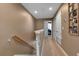 Upstairs hallway with carpet flooring, neutral paint, and doors leading to bedrooms and storage at 6265 Fairmont Ln, Palmetto, FL 34221