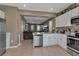 Bright and open kitchen flows into living space, featuring stainless steel appliances at 6265 Fairmont Ln, Palmetto, FL 34221