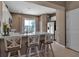 Bright kitchen features a quartz countertop island with stylish seating, and stainless steel appliances at 6265 Fairmont Ln, Palmetto, FL 34221
