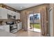 Well-lit kitchen showcases white cabinetry, stainless steel appliances and direct backyard access at 6265 Fairmont Ln, Palmetto, FL 34221