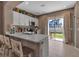 Modern kitchen features white cabinets, quartz counters, and a sliding glass door leading to the backyard at 6265 Fairmont Ln, Palmetto, FL 34221