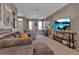 Bright and airy living area with a large TV, comfortable sofa, and stylish decor at 6265 Fairmont Ln, Palmetto, FL 34221