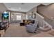 Spacious living room with plush seating, a cozy carpet, and an open view to the kitchen at 6265 Fairmont Ln, Palmetto, FL 34221